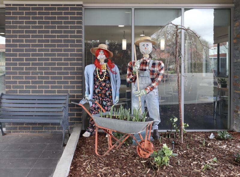 Two keen gardeners and a wheelbarrow