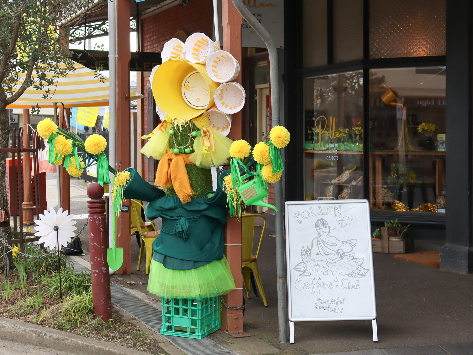A scarecrow dressed as a giant daffodil outside Pollen on High Street